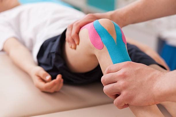 Pateint getting assessed and terated for a sports in jusry at Seed and Sprout Family Chiropractic